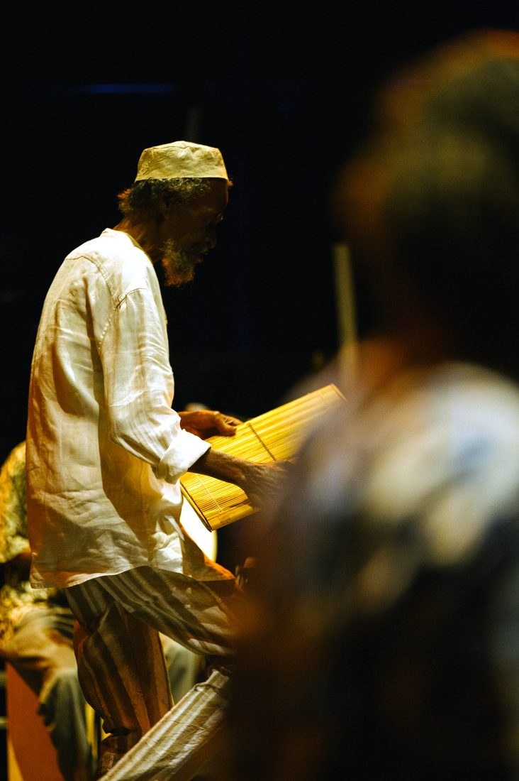 menwar bent over an instrument